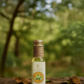 Bottle of honey vanilla product on a wooden surface with a natural background